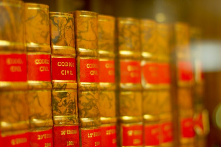 a row of red and yellow books on a shelf
